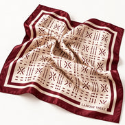 Burgundy and cream Adire-inspired silk satin scarf softly draped