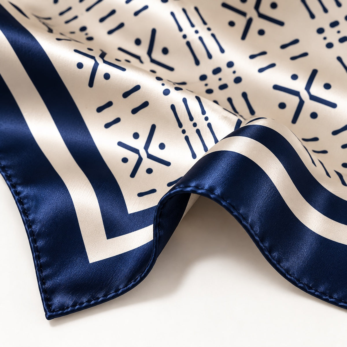 Close-up of Midnight Navy Adire-inspired silk scarf with hand-rolled edge